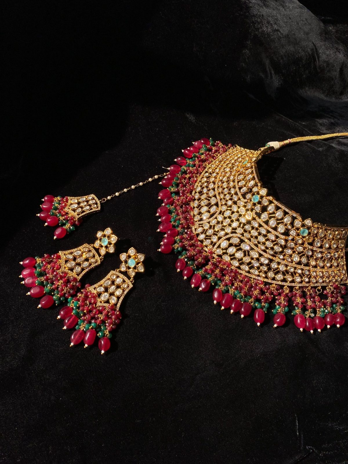 Mehrunisa Bridal Set with ruby and emerald bead accents.