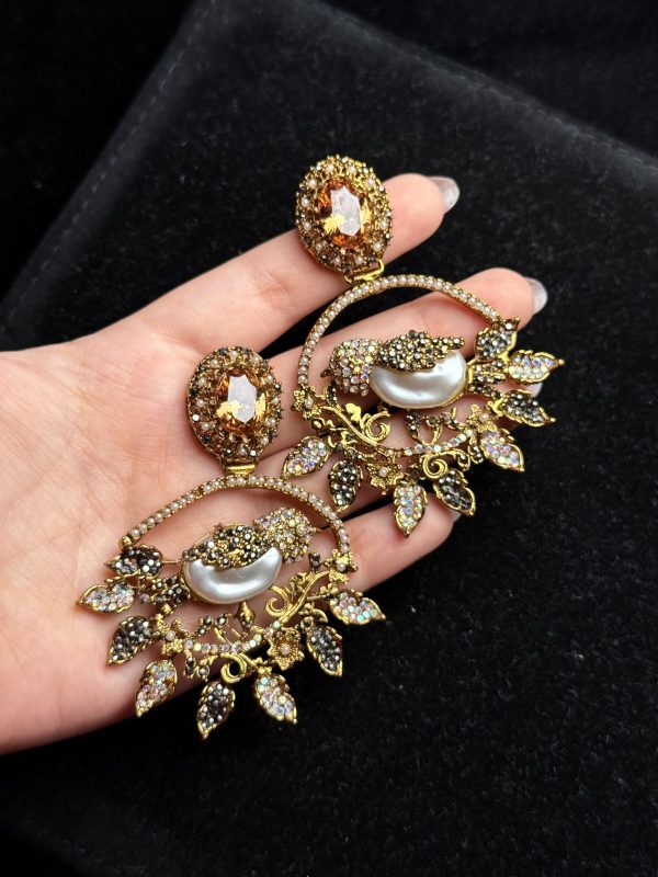 Ornate filigree birdcage drop earrings with a pearl and crystals in champagne