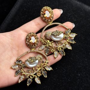 Ornate filigree birdcage drop earrings with a pearl and crystals in champagne