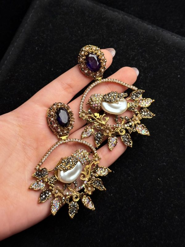 Ornate filigree birdcage drop earrings with a pearl and crystals in Purple