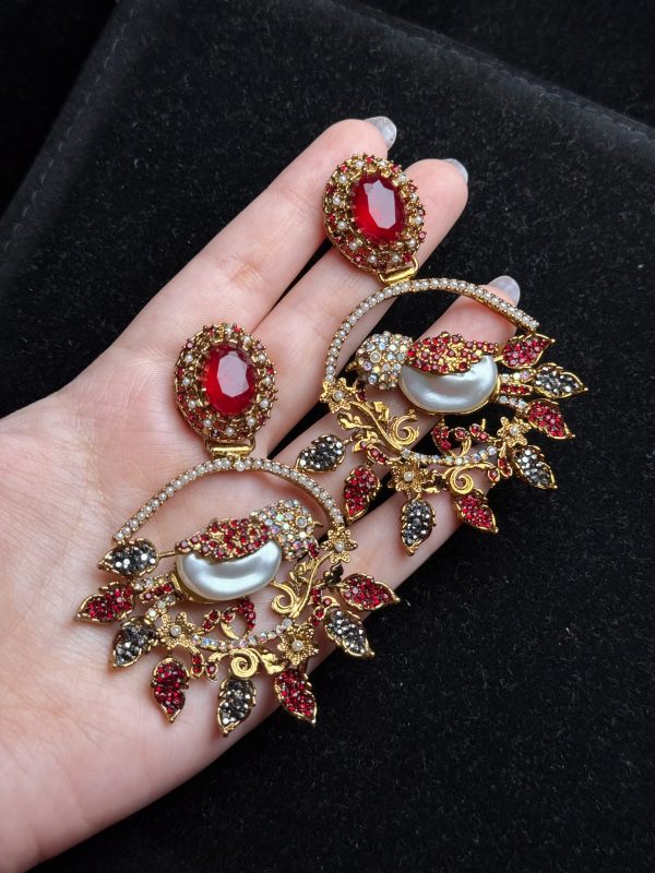 Ornate filigree birdcage drop earrings with a pearl and crystals in red
