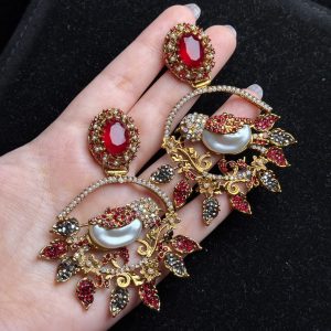 Ornate filigree birdcage drop earrings with a pearl and crystals in red