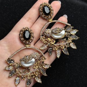Ornate filigree birdcage drop earrings with a pearl and crystals in black