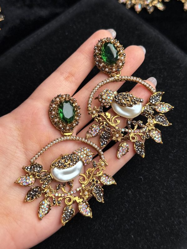 Ornate filigree birdcage drop earrings with a pearl and crystals in Green with black.