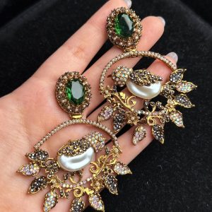 Ornate filigree birdcage drop earrings with a pearl and crystals in Green with black.