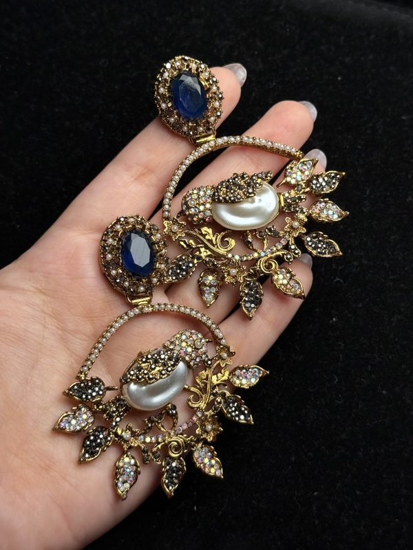Ornate filigree birdcage drop earrings with a pearl and crystals in midnight blue with black