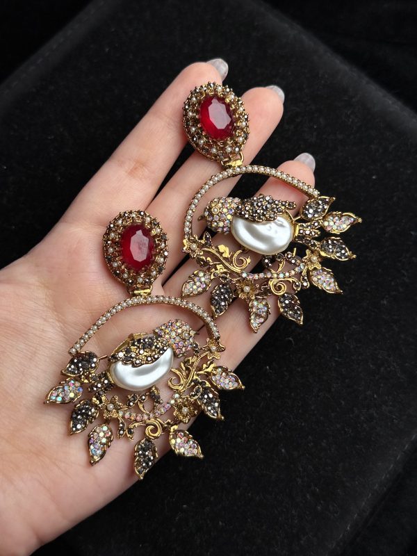 Ornate filigree birdcage drop earrings with a pearl and crystals in red