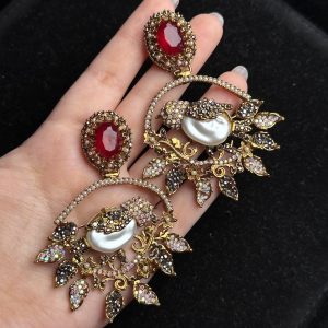 Ornate filigree birdcage drop earrings with a pearl and crystals in red