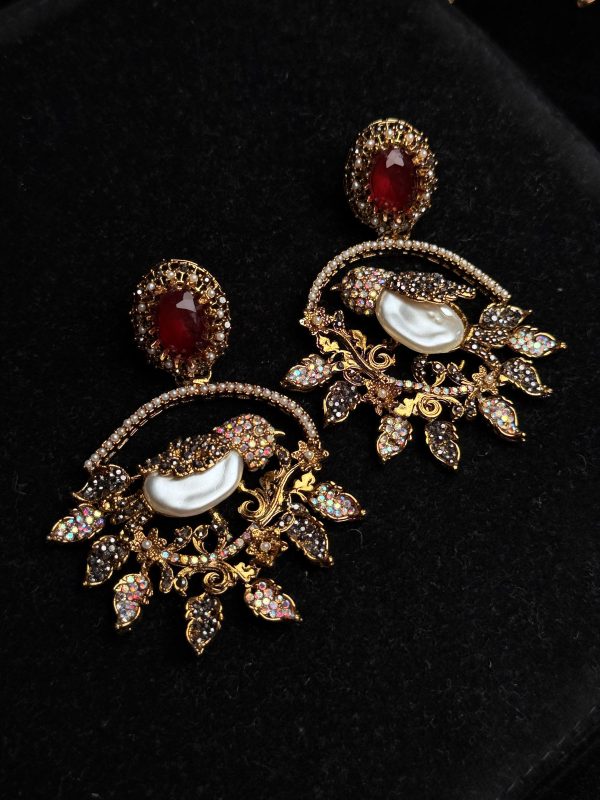 Ornate filigree birdcage drop earrings with a pearl and crystals in red
