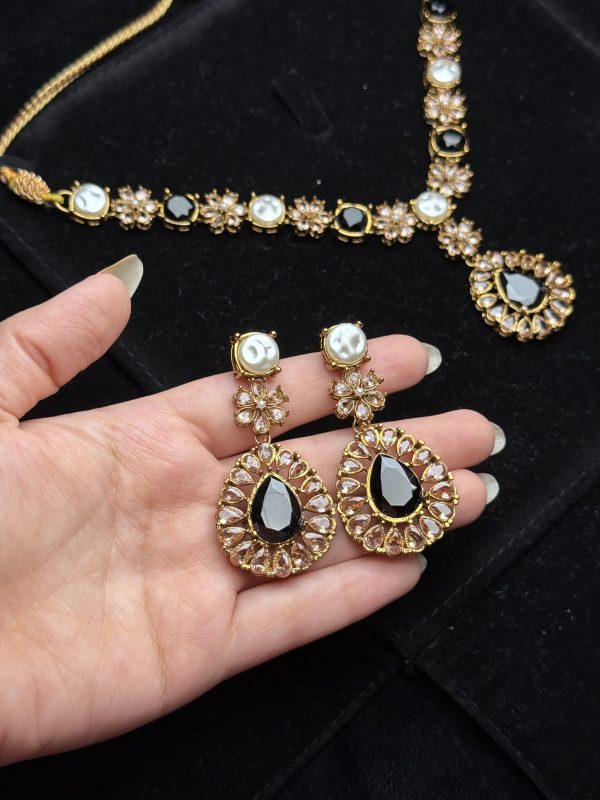 Whispering Blossom necklace and earrings set with pearls and petal-shaped gemstones in Black