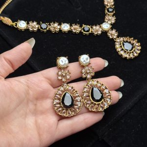 Whispering Blossom necklace and earrings set with pearls and petal-shaped gemstones in Black