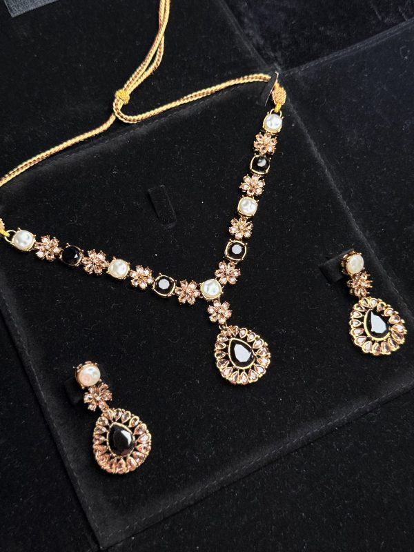Whispering Blossom necklace and earrings set with pearls and petal-shaped gemstones in Black