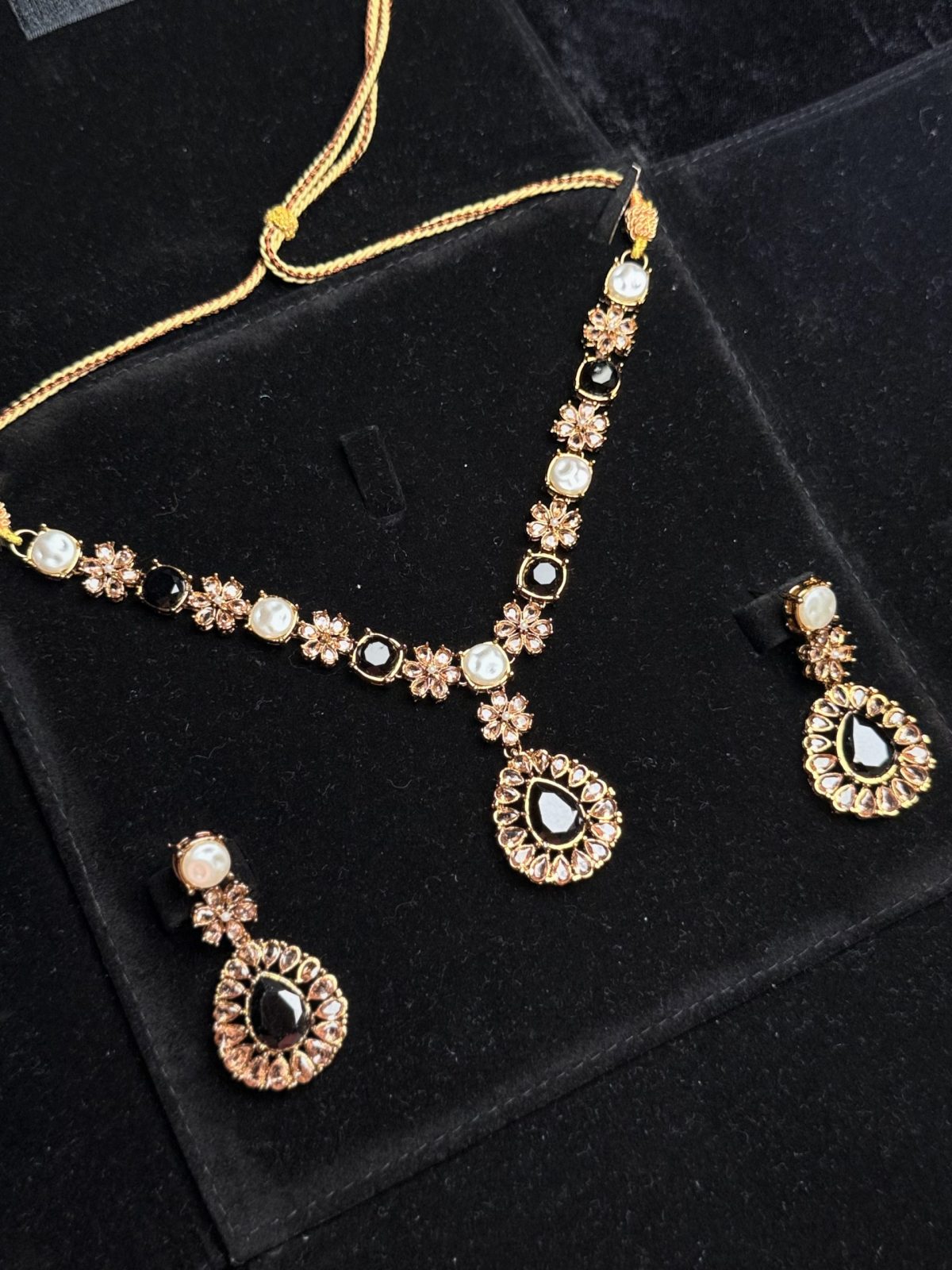 Whispering Blossom necklace and earrings set with pearls and petal-shaped gemstones in Black