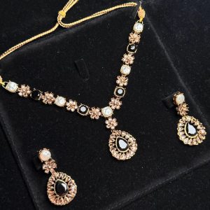 Whispering Blossom necklace and earrings set with pearls and petal-shaped gemstones in Black