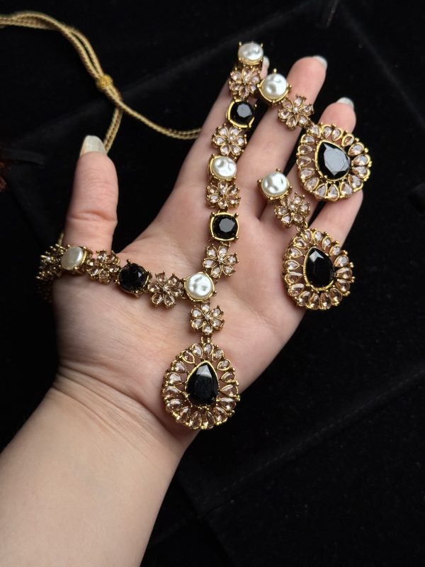 Whispering Blossom necklace and earrings set with pearls and petal-shaped gemstones in Black