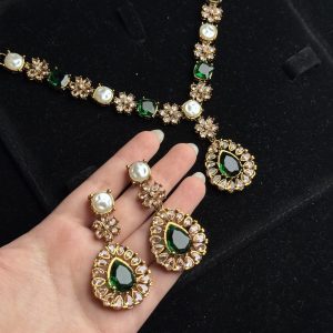 Whispering Blossom necklace and earrings set with pearls and petal-shaped gemstones in Green