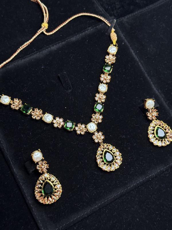 Whispering Blossom necklace and earrings set with pearls and petal-shaped gemstones in Green