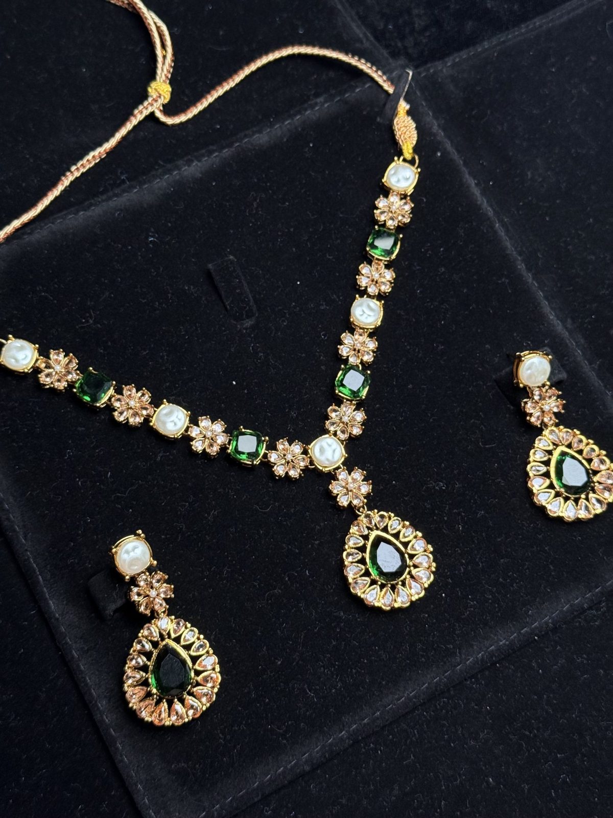 Whispering Blossom necklace and earrings set with pearls and petal-shaped gemstones in Green