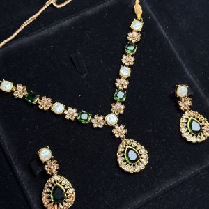 Whispering Blossom necklace and earrings set with pearls and petal-shaped gemstones in Green
