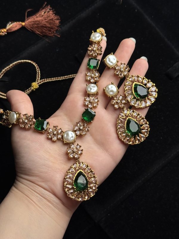 Whispering Blossom necklace and earrings set with pearls and petal-shaped gemstones in Green