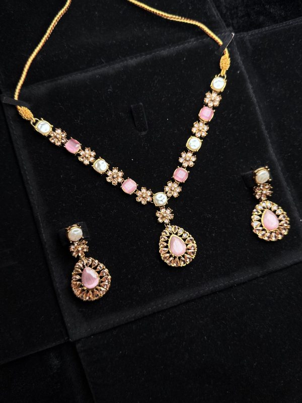 Whispering Blossom necklace and earrings set with pearls and petal-shaped gemstones in Pink