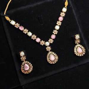 Whispering Blossom necklace and earrings set with pearls and petal-shaped gemstones in Pink