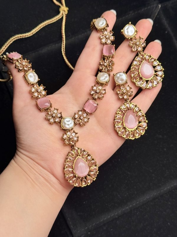 Whispering Blossom necklace and earrings set with pearls and petal-shaped gemstones in Pink