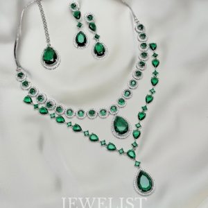 Twilight Brilliance Set by Jewelist.pk – elegant two-layer emerald green necklace set featuring teardrop stones, cubic zircon accents, and matching earrings for bridal and formal wear.