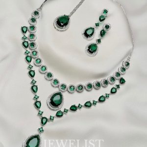 Twilight Brilliance Set by Jewelist.pk – elegant two-layer emerald green necklace set featuring teardrop stones, cubic zircon accents, and matching earrings for bridal and formal wear.