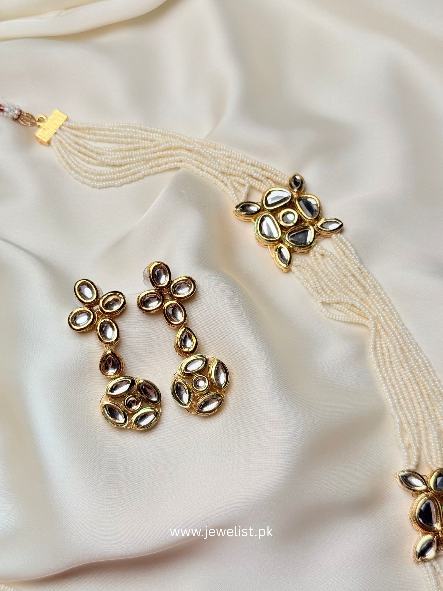 Aarya Kundan Set close-up with pearl strands and reflective kundan drop earrings