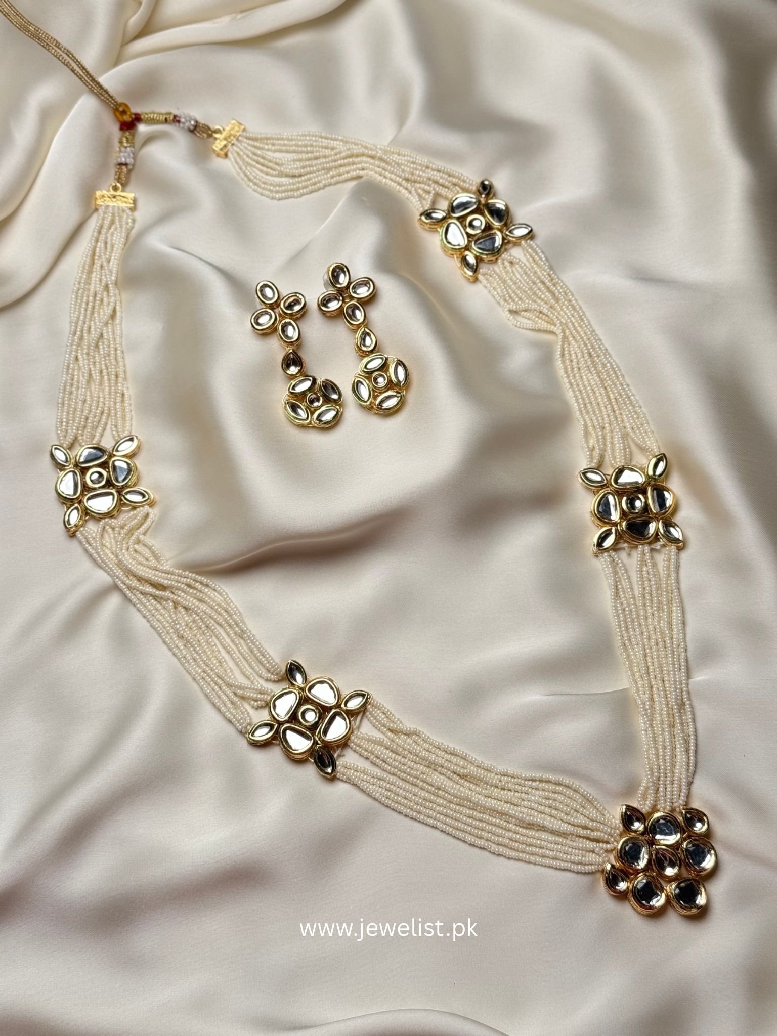 Aarya Kundan Set multi-strand pearl necklace with floral kundan motifs and matching earrings