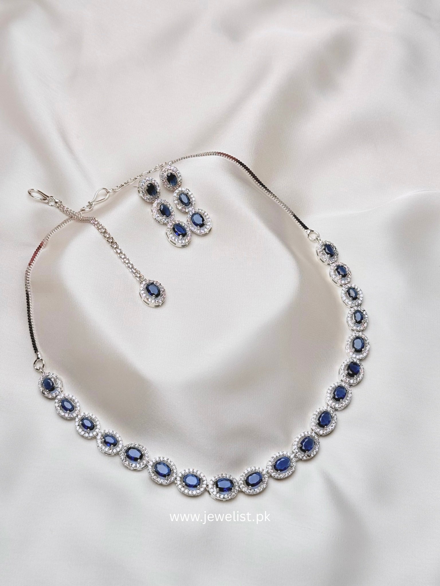 Elise Oval Solitaire Set in blue with repeating oval halo accents and matching jewelry
