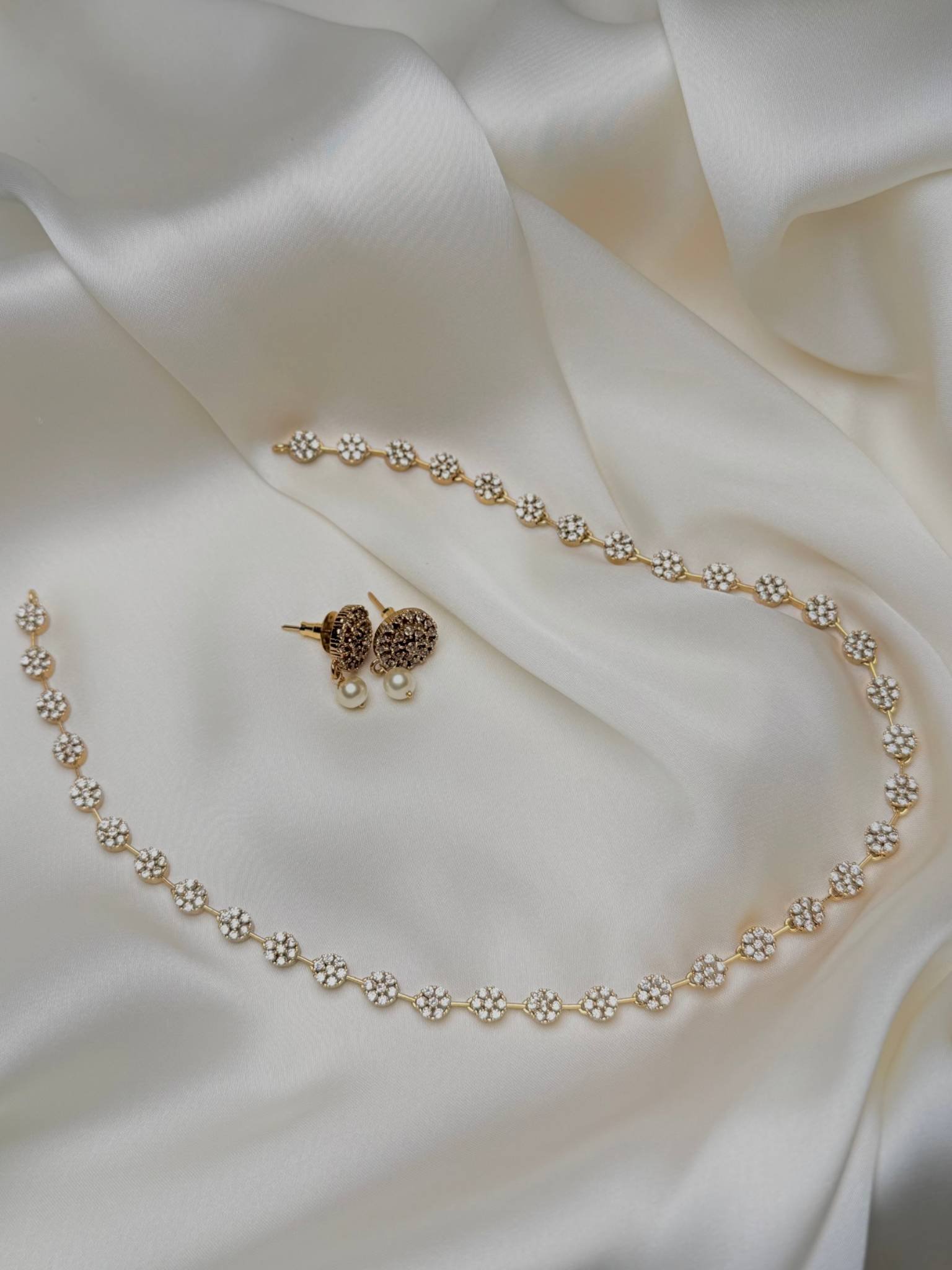 Rosette Trail Mala Set close-up with gold-tone floral clusters and pearl-like drop earrings