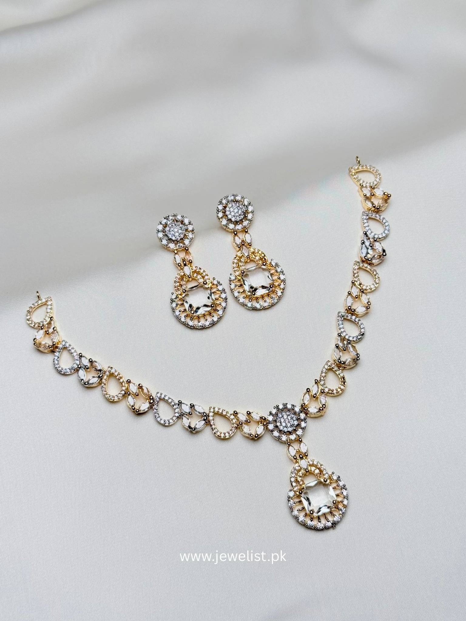 Teardrop Halo Necklace Set in gold and silver tone with clear geometric pendant and matching earrings