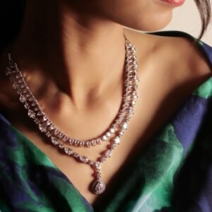 Silver Tone Teardrop Necklace Set clear variation styled on model with layered cascade pendant