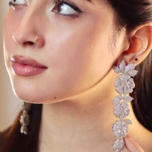 Crystal flora drops long sparkling floral earrings styled on model with silver-tone finish