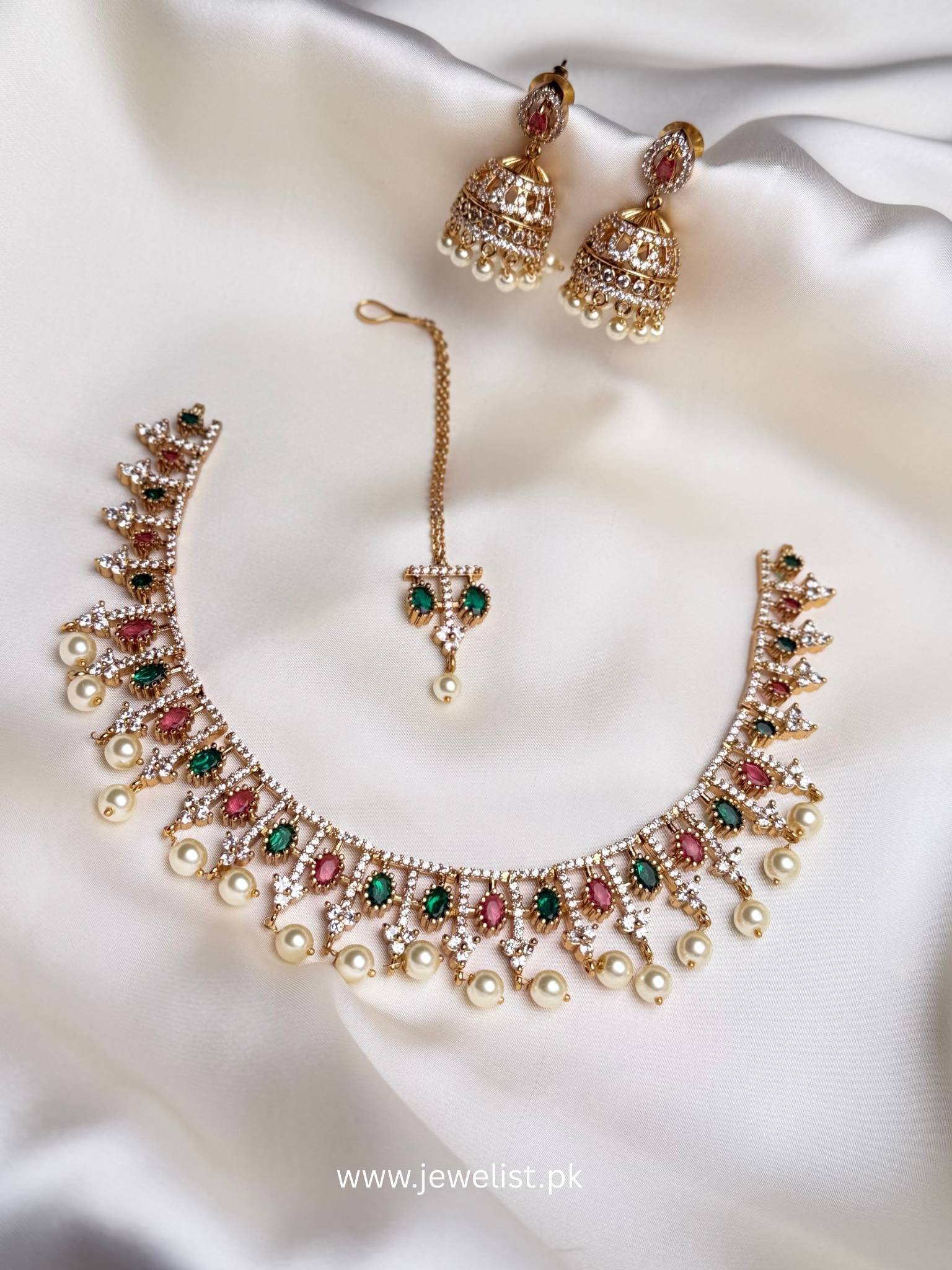 Mehr Moti Choker Set with pink green accents, jhumka earrings, teeka and pearl-like drops